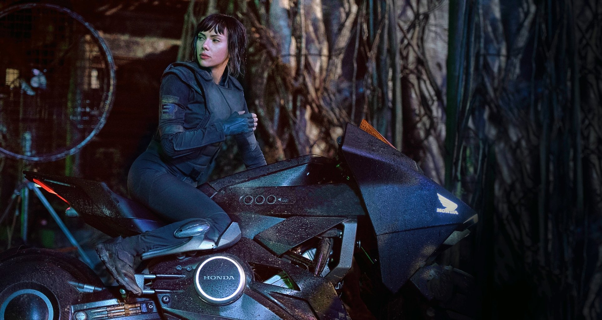 Scarlett Johansson as Major on a futuristic motorcycle in the 2017 movie Ghost in the Shell, shown in a detailed 4K Ultra HD PC desktop wallpaper.