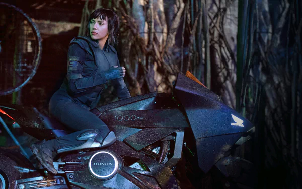 Scarlett Johansson as Major on a futuristic motorcycle in the 2017 movie Ghost in the Shell, shown in a detailed 4K Ultra HD PC desktop wallpaper.