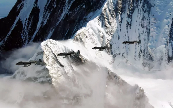 Four Fairchild Republic A-10 Thunderbolt II jets fly over majestic snowy mountains, creating a striking military aviation scene in high-definition wallpaper format.