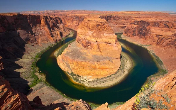 HD desktop wallpaper featuring the natural curves of Horseshoe Bend, where a river winds dramatically through rugged desert terrain.