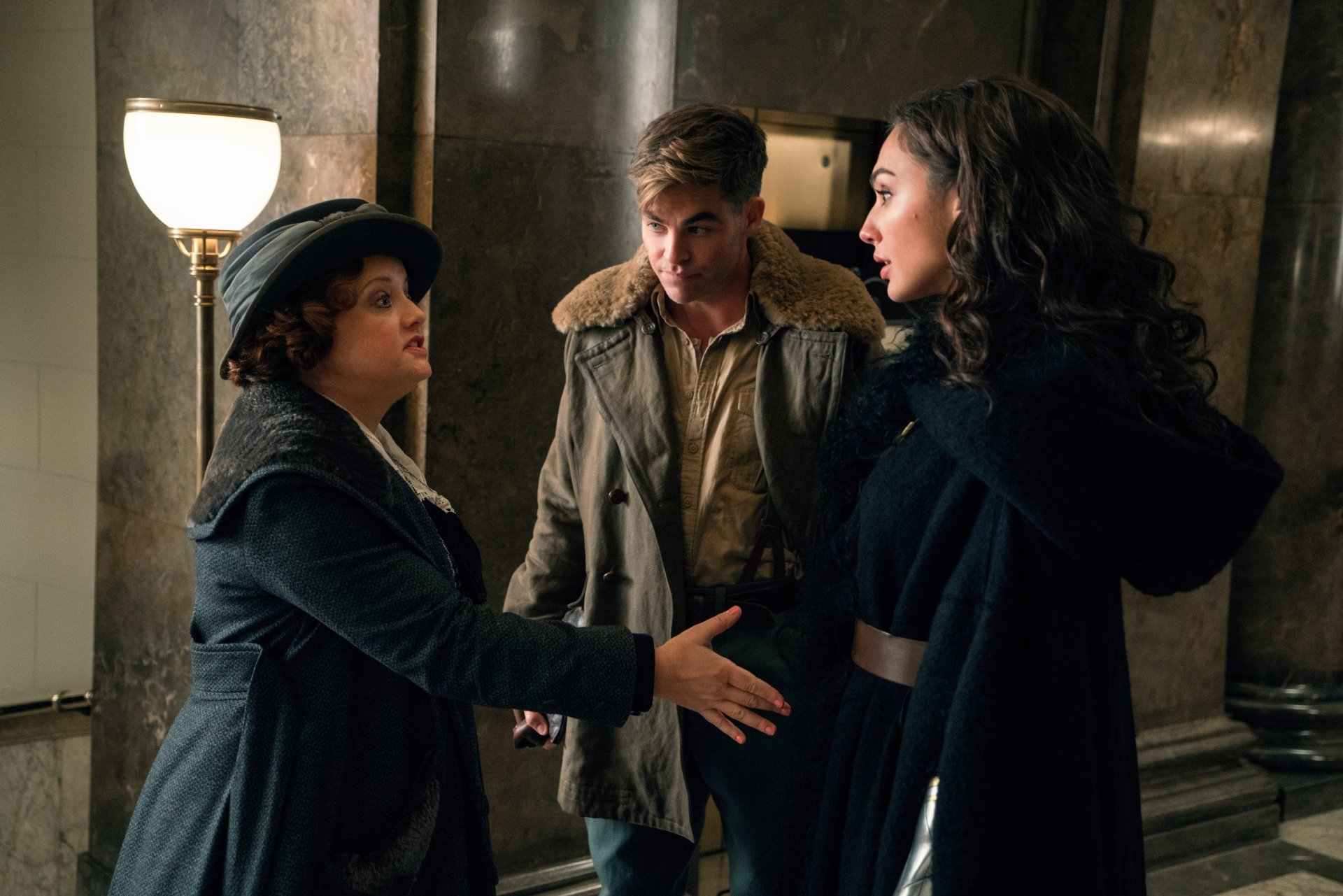 Gal Gadot, Chris Pine, and another actor discuss in a scene from the movie Wonder Woman. This HD wallpaper features them in costume in a historical setting. Tags: Steve Trevor, Chris Pine, Gal Gadot, movie, Wonder Woman.