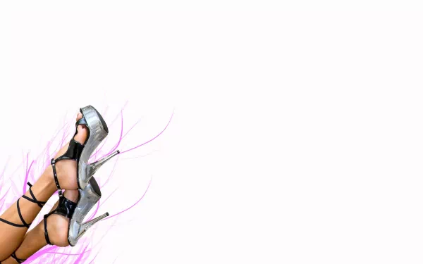 A stylish close-up of a woman’s legs and high heels, set against a minimalist background with soft pink accents, creating a striking HD desktop wallpaper.