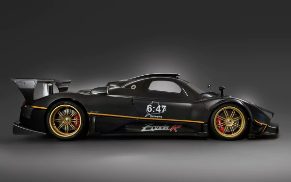 HD desktop wallpaper featuring a sleek black Pagani Zonda R supercar with gold accents, showcasing its aerodynamic design and performance-oriented details.