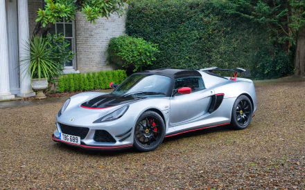 Silver and black 2017 Lotus Exige Sport 380 supercar parked on gravel by a manor, detailed Lotus Exige vehicle — 2K Quad HD PC desktop wallpaper/background.