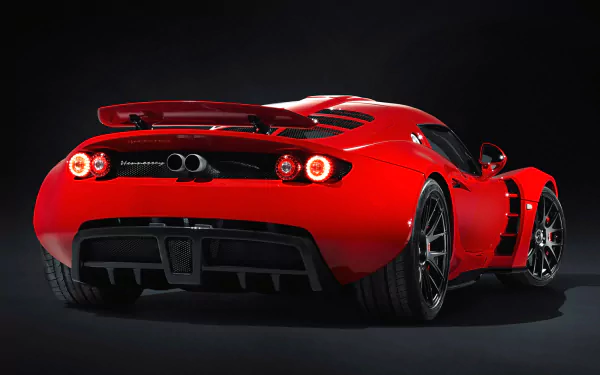 Rear three-quarter view of a red Hennessey Venom GT supercar on a dark backdrop — HD PC desktop wallpaper showcasing a high-performance vehicle.