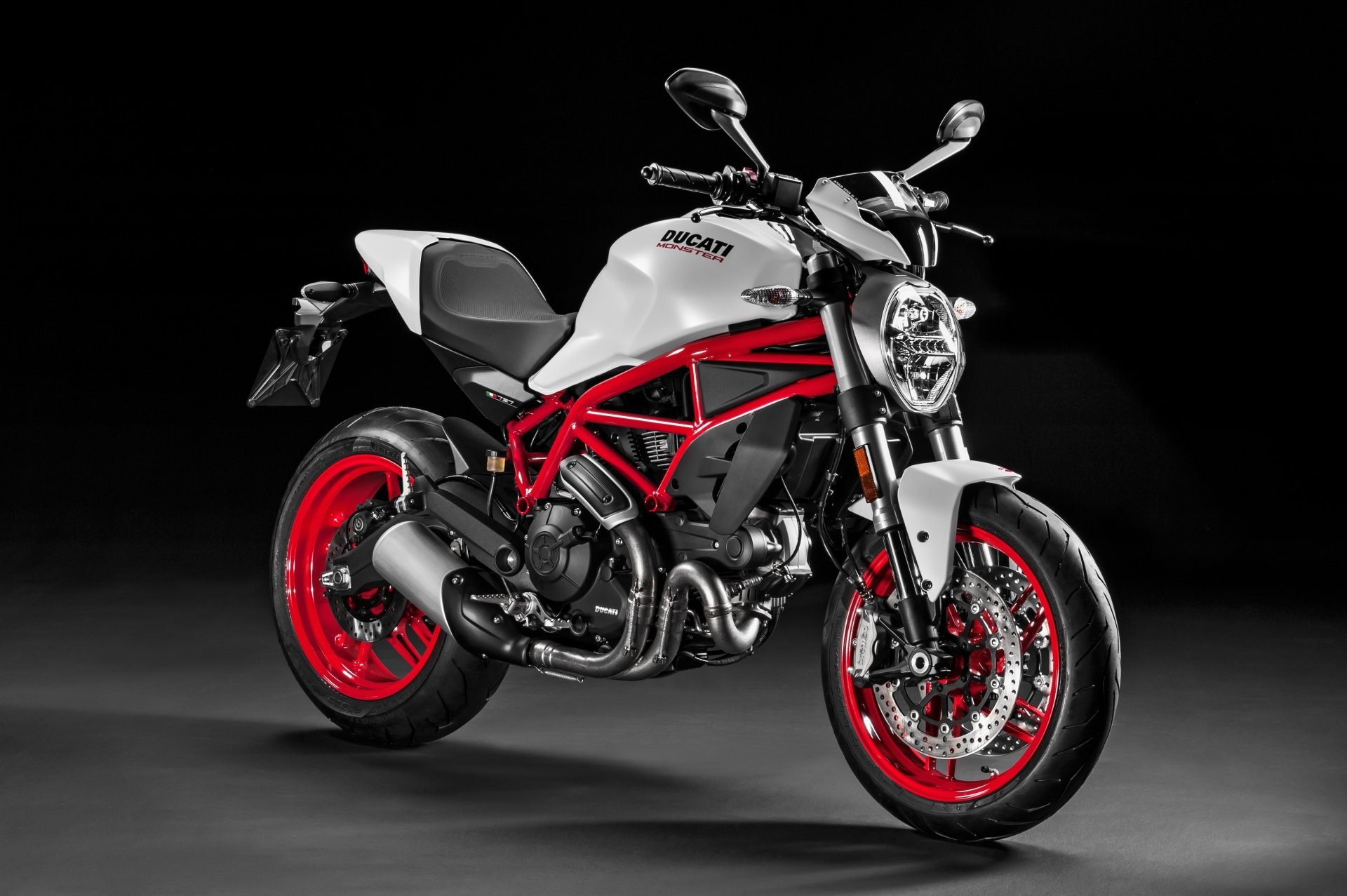 White-and-red Ducati Monster vehicle (motorcycle) on a black backdrop, 4K Ultra HD PC desktop wallpaper.