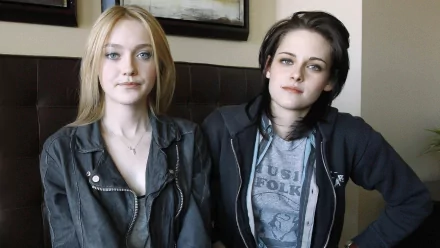 Dakota Fanning and Kristen Stewart pose together in a candid moment, showcasing their distinct styles as celebrated actresses in this HD desktop wallpaper.