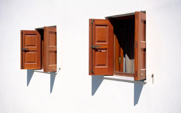 A 4K Ultra HD man-made desktop wallpaper featuring two open wooden windows casting shadows on a white wall.