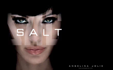 HD PC desktop wallpaper featuring Angelina Jolie's intense close-up from the movie Salt, with the title prominently displayed across her face.