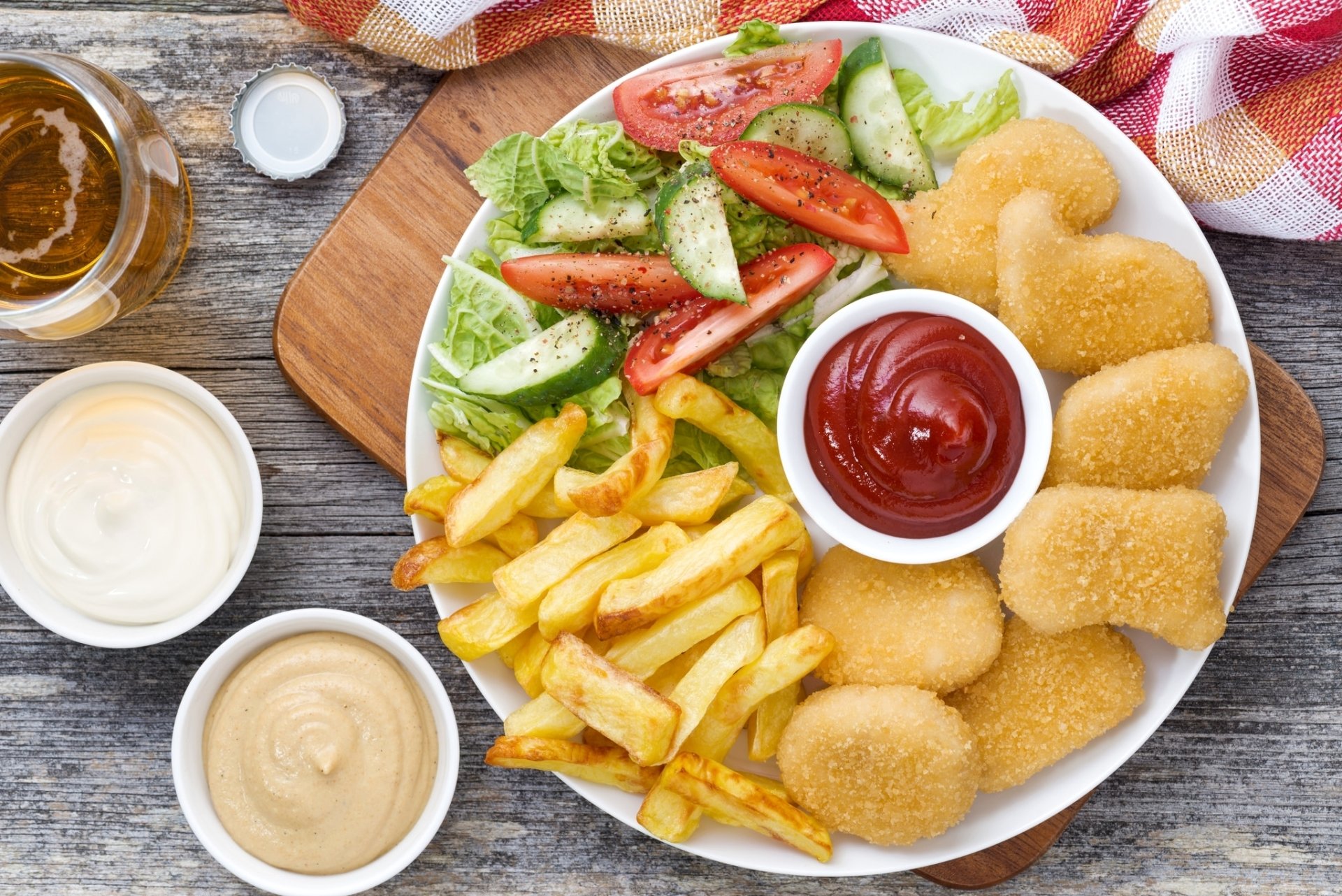 HD desktop wallpaper featuring a meal with chicken nuggets, French fries, ketchup, and fresh salad on a wooden board.