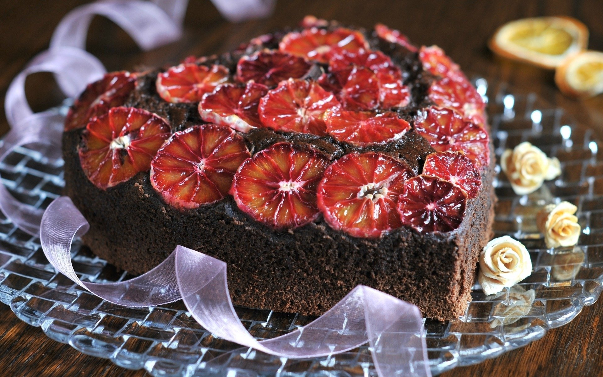 HD PC desktop wallpaper background: heart-shaped chocolate pastry cake topped with glazed blood-orange slices and cream accents — appetizing food image.