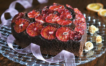 HD PC desktop wallpaper background: heart-shaped chocolate pastry cake topped with glazed blood-orange slices and cream accents — appetizing food image.