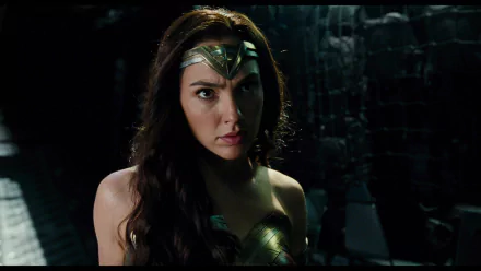 HD desktop wallpaper featuring Gal Gadot as Wonder Woman from the 2017 Justice League movie, showing her fierce and determined expression in a dark setting.