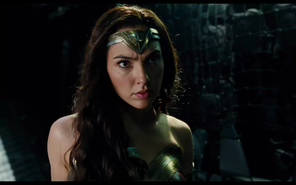 HD desktop wallpaper featuring Gal Gadot as Wonder Woman from the 2017 Justice League movie, showing her fierce and determined expression in a dark setting.