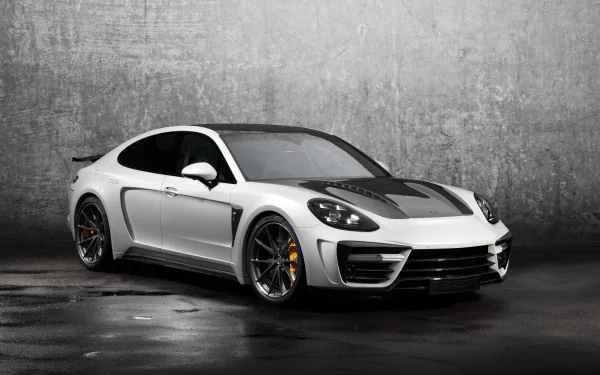 White Porsche Panamera Stingray GTR parked before a textured concrete wall — sleek high-performance vehicle; 4K Ultra HD PC desktop wallpaper and background.
