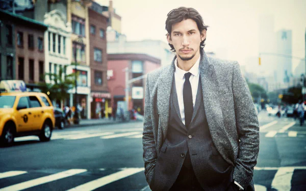 HD wallpaper featuring a man in a suit standing on a city street with a yellow taxi in the background.