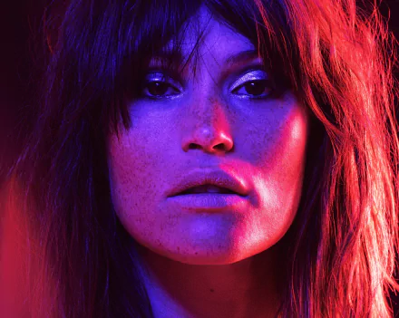 Close-up 4K Ultra HD wallpaper of celebrity Gemma Arterton bathed in vibrant neon purple and red lighting, enhancing her striking features.