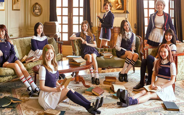 Twice members sitting in a cozy, vintage-style room with books scattered around, creating a lively and artistic atmosphere. HD desktop wallpaper and background.