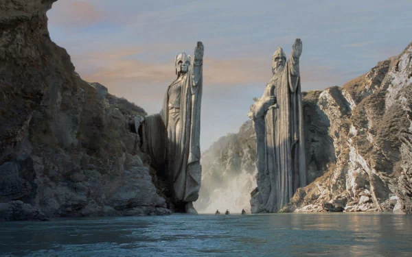 HD wallpaper featuring a scene from The Lord of the Rings: The Fellowship of the Ring with the majestic Argonath statues standing tall beside a serene river.