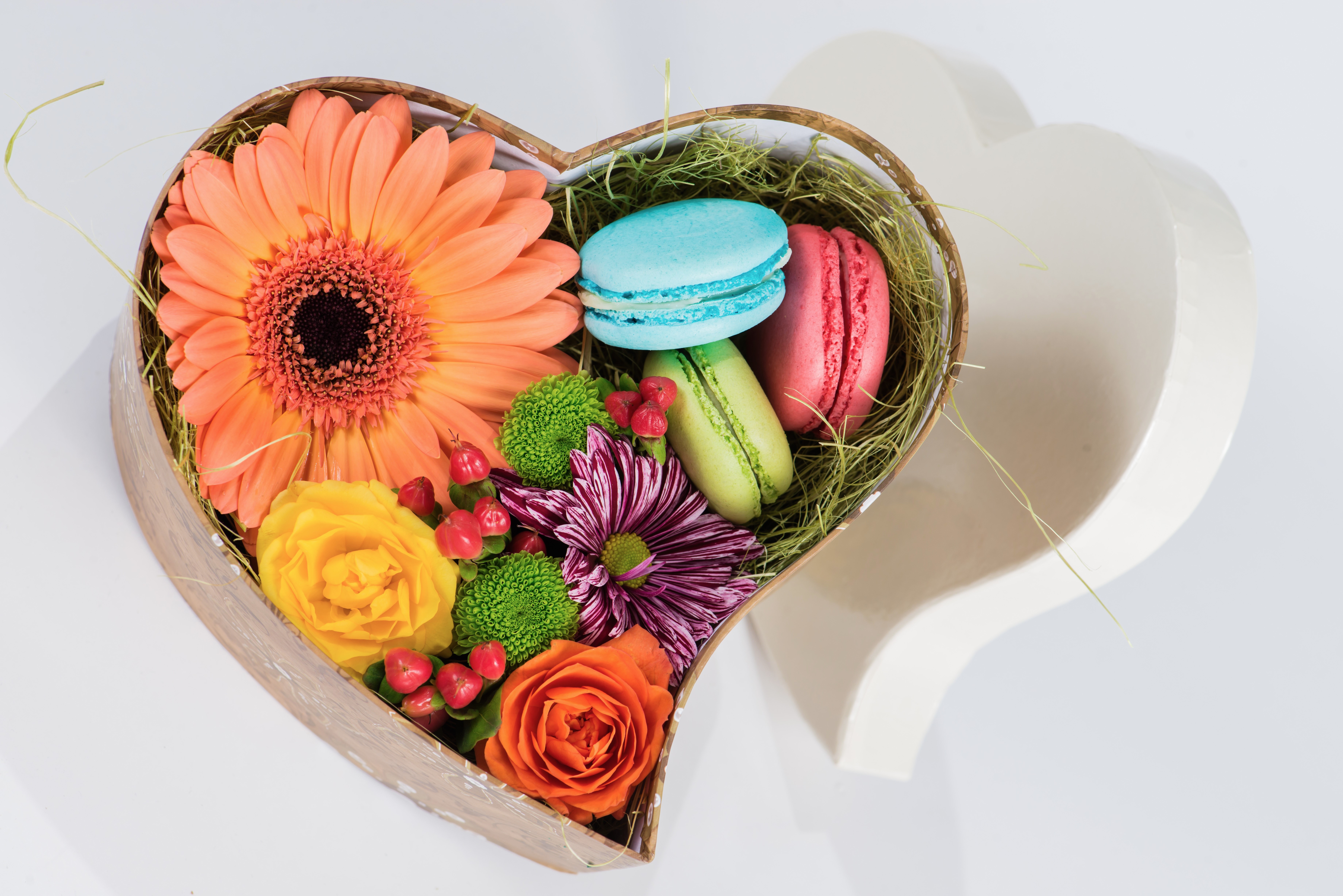 Flowers and macarons in heart shaped box