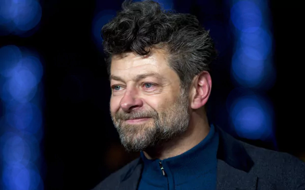 HD desktop wallpaper featuring a portrait of Andy Serkis with a focused expression and a blurred blue light background.