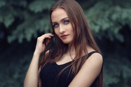 A brunette woman model with blue eyes and lipstick poses against a blurred natural background, captured in sharp 4K Ultra HD with depth of field effect.