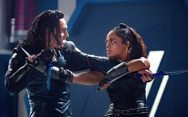 Tessa Thompson and Tom Hiddleston as Valkyrie and Loki from Marvel's Thor: Ragnarok engage in a tense battle scene. HD desktop wallpaper featuring characters from the movie.