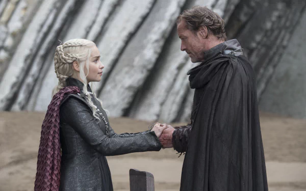 Daenerys Targaryen and Jorah Mormont from Game of Thrones clasp hands on a rocky shore; 5K Ultra HD PC desktop wallpaper/background.