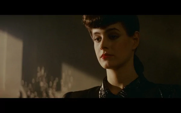 A captivating HD wallpaper from the movie Blade Runner, featuring a dramatic close-up of a female character with striking makeup and an intense expression, set against a moody backdrop.