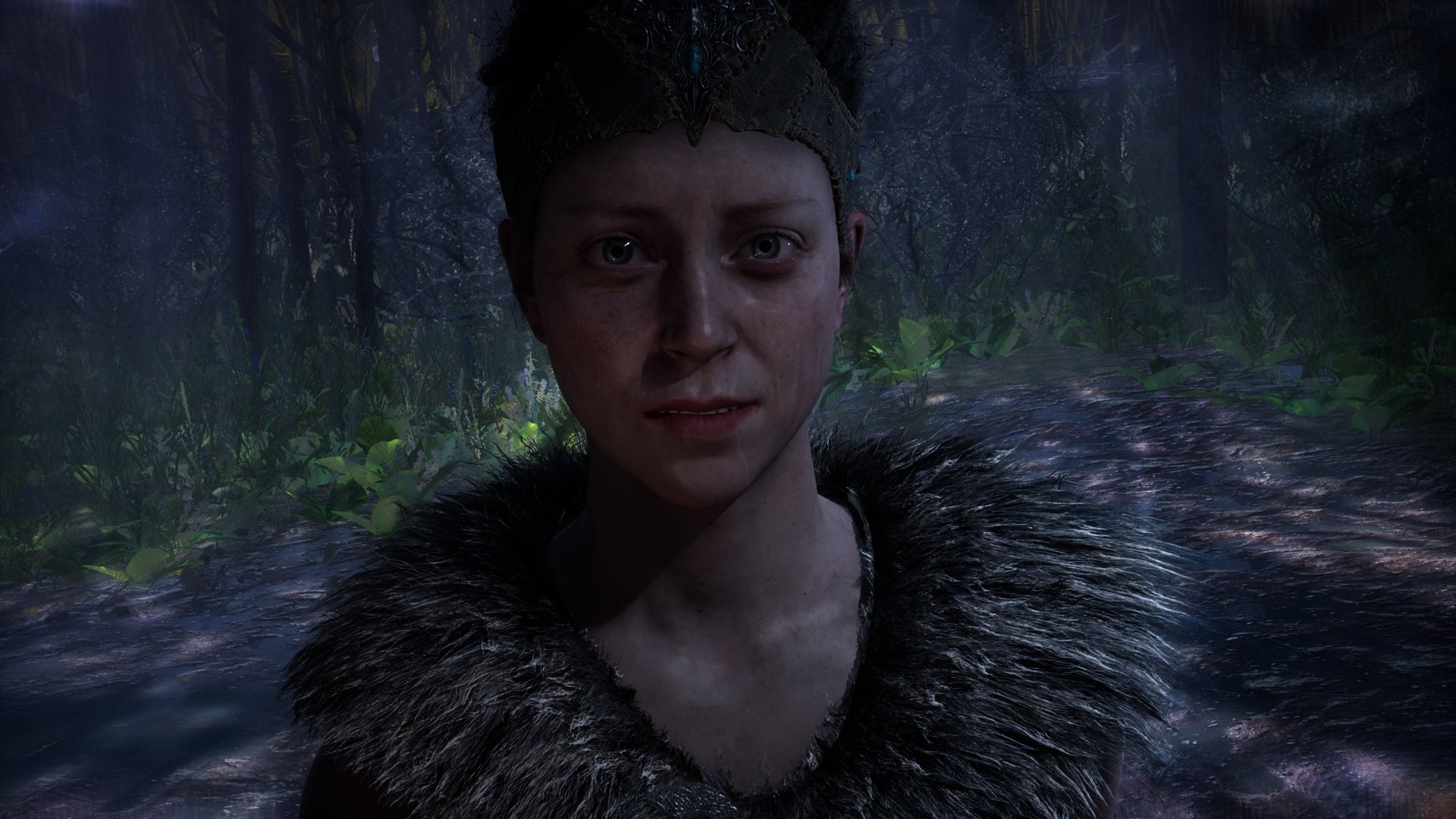 Senua from the video game Hellblade: Senua's Sacrifice — close-up portrait in a rain-soaked dark forest, 4K Ultra HD PC desktop wallpaper and background.