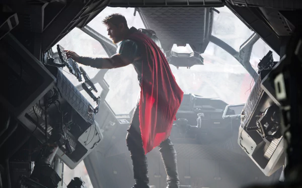 Thor, played by Chris Hemsworth, inside a spaceship cockpit in a scene from the movie Thor: Ragnarok. The HD desktop wallpaper captures him in action with his iconic red cape.