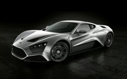 A sleek silver Zenvo ST1 hypercar showcased in an HD desktop wallpaper, highlighting its aerodynamic design and striking features against a dark background.