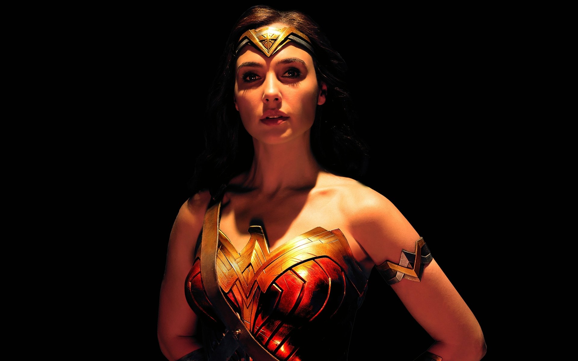 HD desktop wallpaper featuring Gal Gadot as Wonder Woman from the 2017 movie Justice League, against a dark background. Wonder Woman's iconic costume and regal look are highlighted in this striking image.