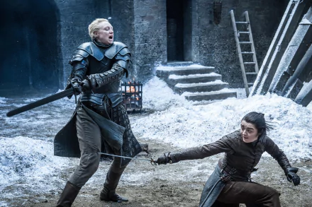 Maisie Williams as Arya Stark and Gwendoline Christie as Brienne of Tarth clash in armor during a dramatic scene from Game of Thrones, captured in 4K Ultra HD.