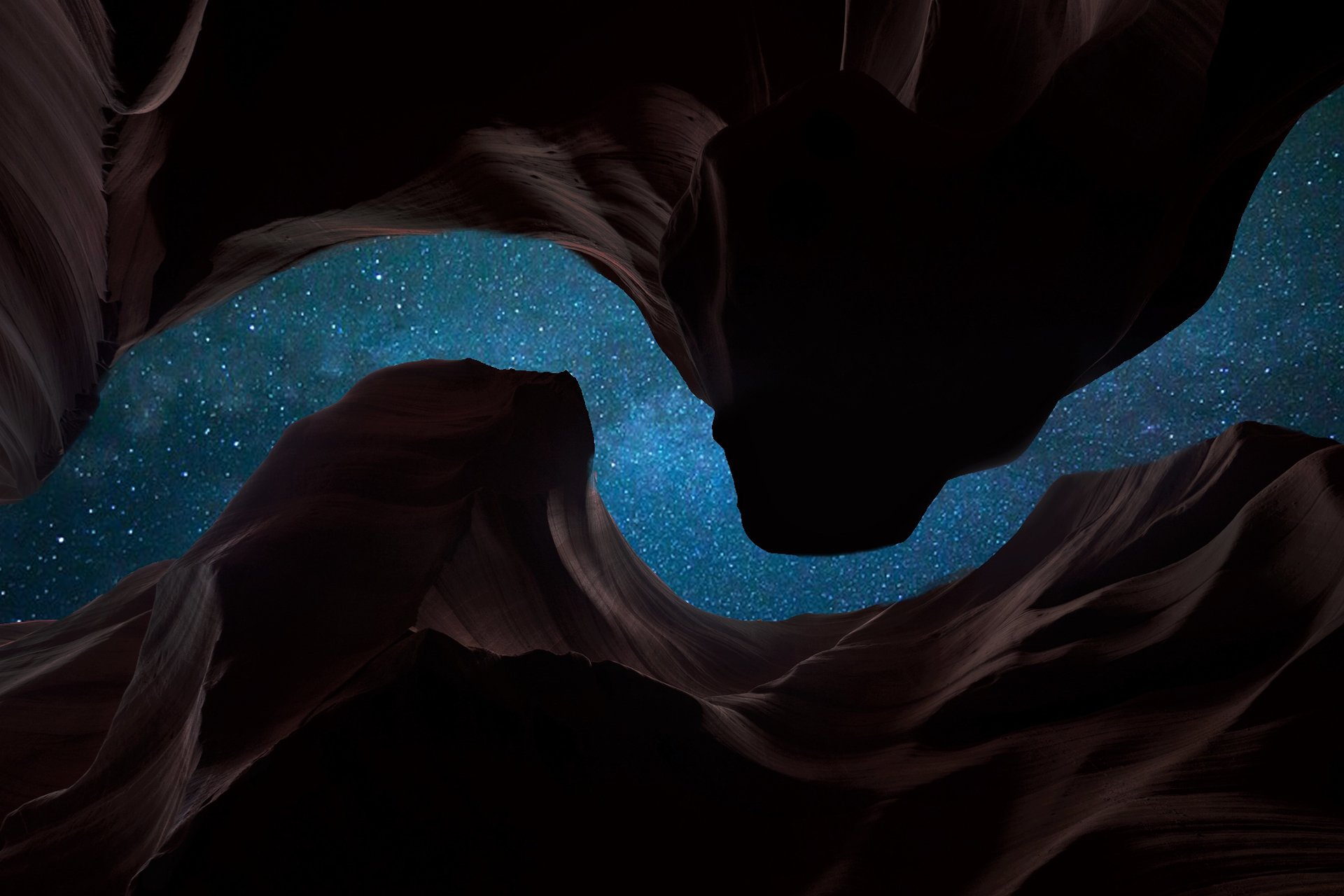 HD wallpaper depicting a starry night sky seen through the silhouette of a canyon. The natural landscape's dark curves contrast beautifully with the brilliant, twinkling stars in the vast sky.