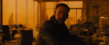 HD PC desktop wallpaper featuring Ryan Gosling as Officer K from the movie Blade Runner 2049 in a dimly lit, industrial setting.
