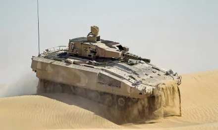 HD desktop wallpaper featuring a Puma infantry fighting vehicle moving through sandy terrain in a military setting.