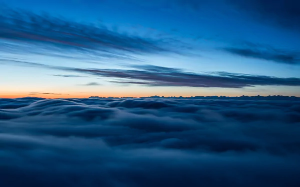 HD desktop wallpaper of a serene sea of clouds beneath a vast sky at the horizon, showcasing the beauty of nature.