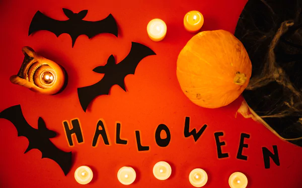 4K Ultra HD Halloween desktop wallpaper featuring bats, a pumpkin, and glowing candles on a vibrant orange background, capturing a spooky holiday atmosphere.