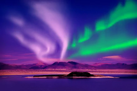 HD desktop wallpaper of an island with a mountainous backdrop, illuminated by vibrant green and purple hues of the aurora borealis, showcasing the beauty of nature in stunning detail.