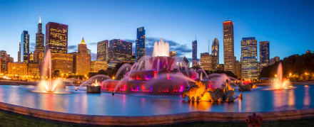 Night view of Chicago’s skyline with illuminated skyscrapers and the iconic Buckingham Fountain glowing in vibrant colors, captured in 4K Ultra HD.