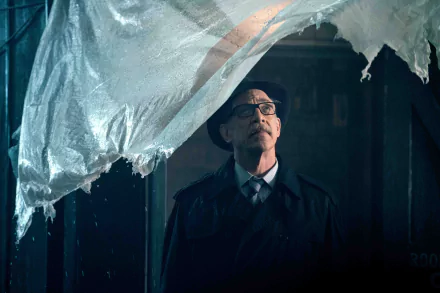 HD PC wallpaper featuring J.K. Simmons as Commissioner Gordon from the Justice League movie, framed through a torn plastic sheet in a dark, moody setting.