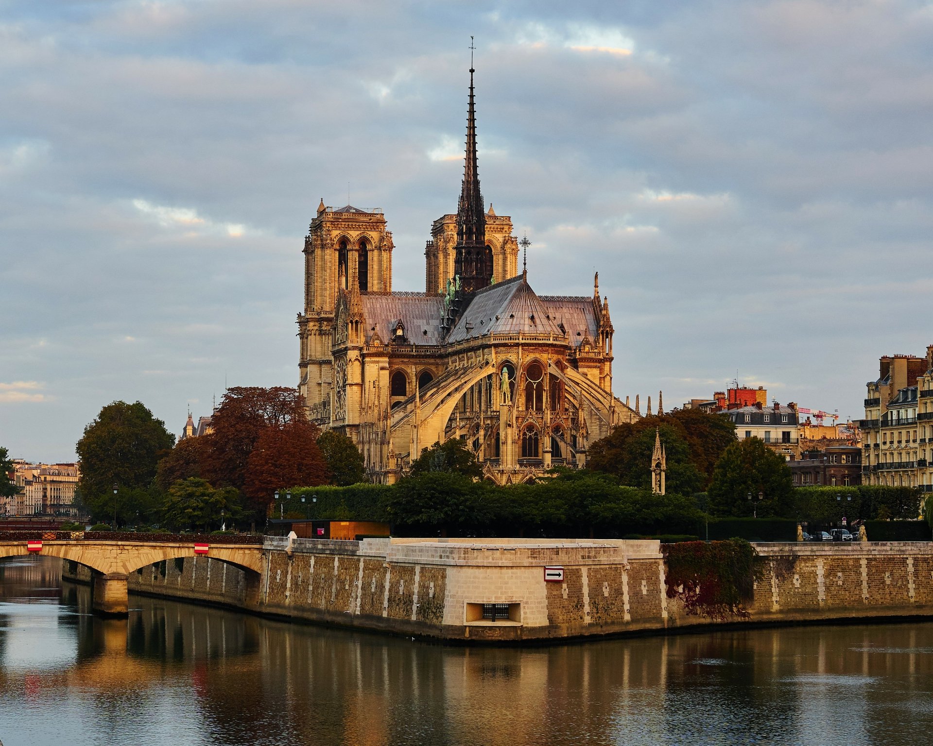 Notre-Dame de Paris cathedral along the Seine in Paris, France at sunrise, Gothic architecture captured as a 4K Ultra HD PC desktop wallpaper, Paris cityscape.