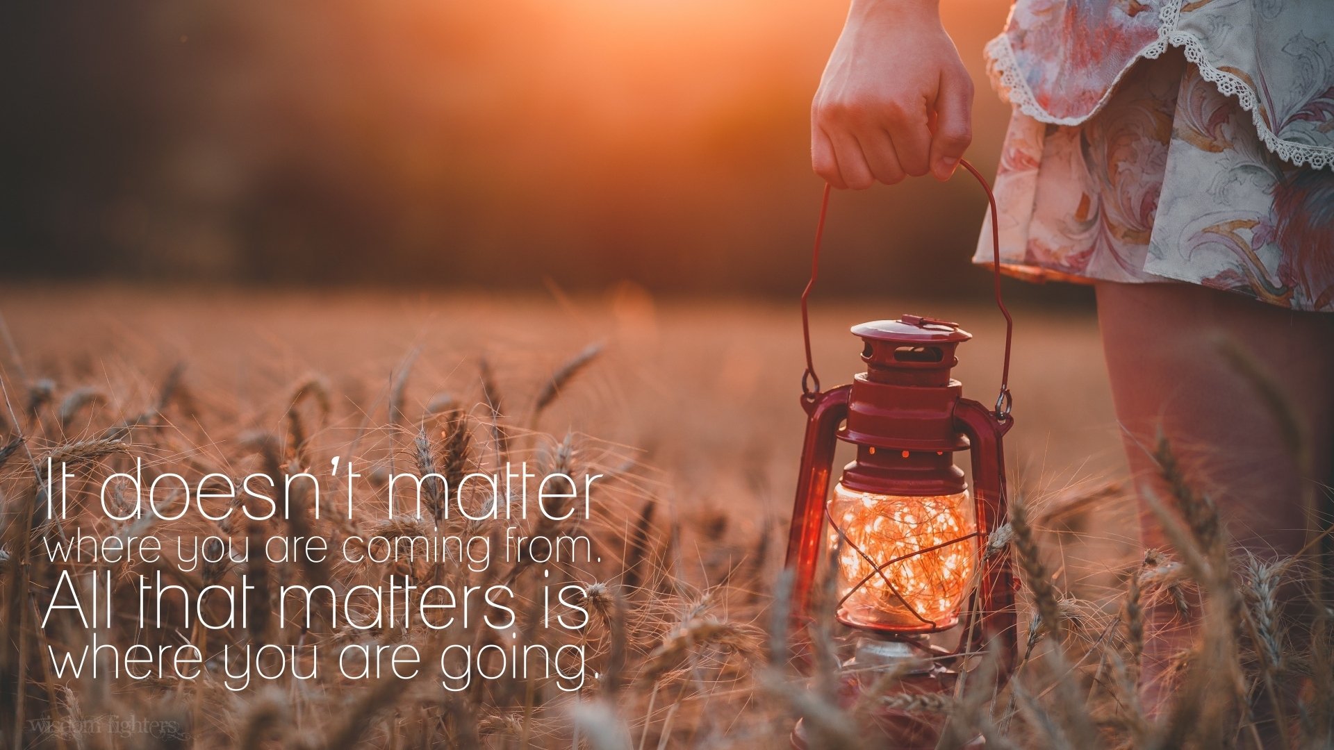 HD PC desktop wallpaper with a motivational quote: It doesn’t matter where you are coming from. All that matters is where you are going, featuring a hand holding a glowing lantern.