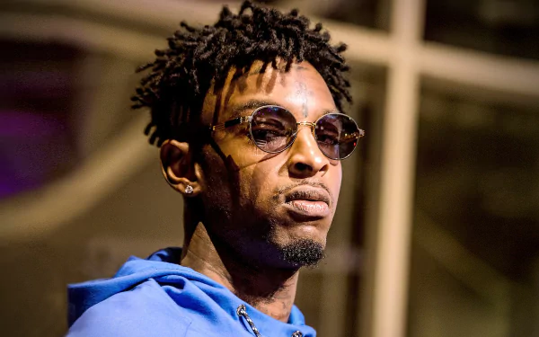 HD desktop wallpaper featuring a person wearing sunglasses and a blue hoodie.