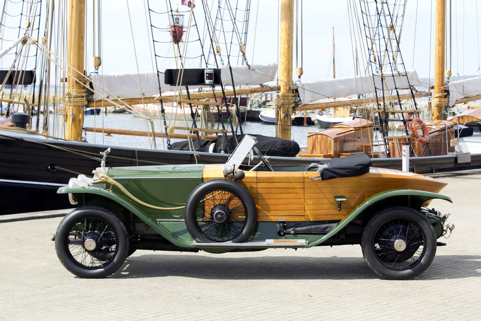 Vintage Rolls-Royce Silver Ghost vehicle parked by a marina, captured in stunning detail for a 4K Ultra HD PC desktop wallpaper and background.