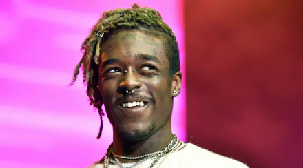 HD desktop wallpaper of Lil Uzi Vert smiling with a colorful background.