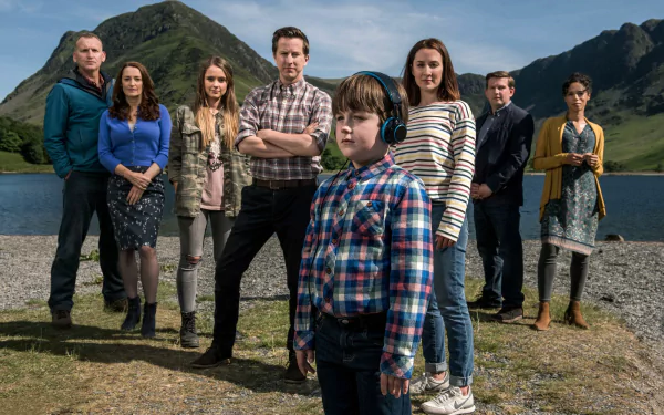 HD desktop wallpaper featuring characters from The A Word standing against a scenic backdrop of hills and a lake.