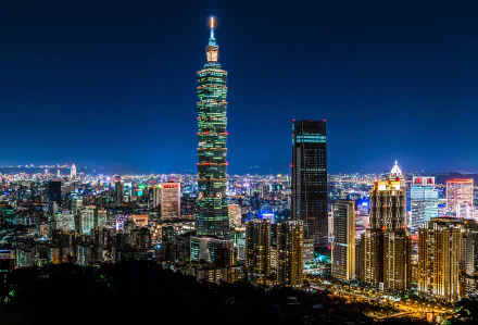 Nighttime cityscape of Taipei, Taiwan, featuring the illuminated Taipei 101 skyscraper among a vibrant urban skyline in 4K Ultra HD resolution.