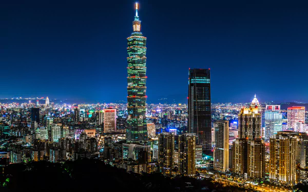 Nighttime cityscape of Taipei, Taiwan, featuring the illuminated Taipei 101 skyscraper among a vibrant urban skyline in 4K Ultra HD resolution.